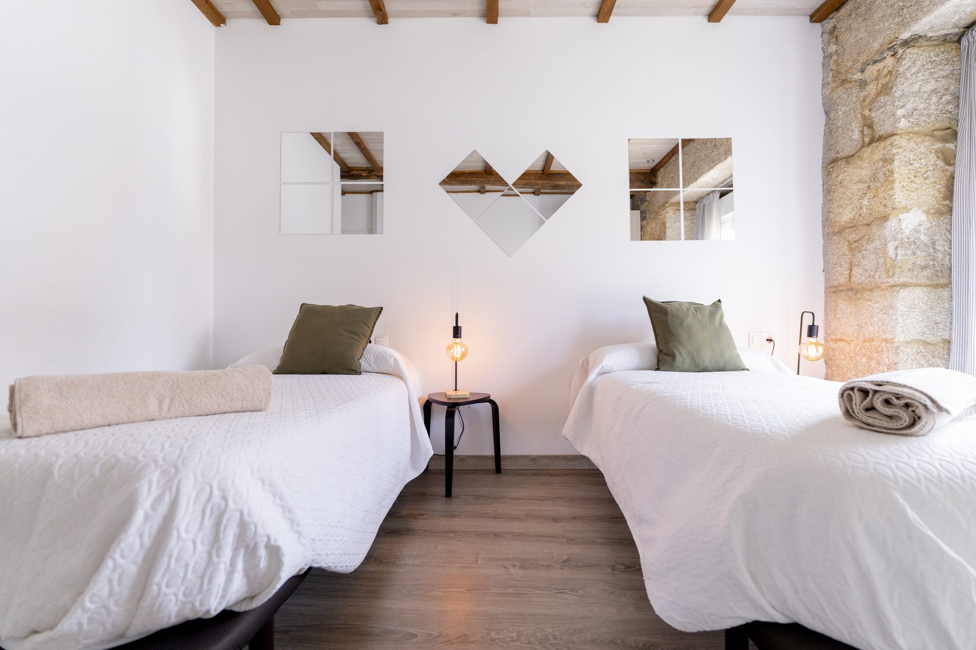 Galería - Dormitorio compartido de Casa Bubela Dozón con pared de piedra